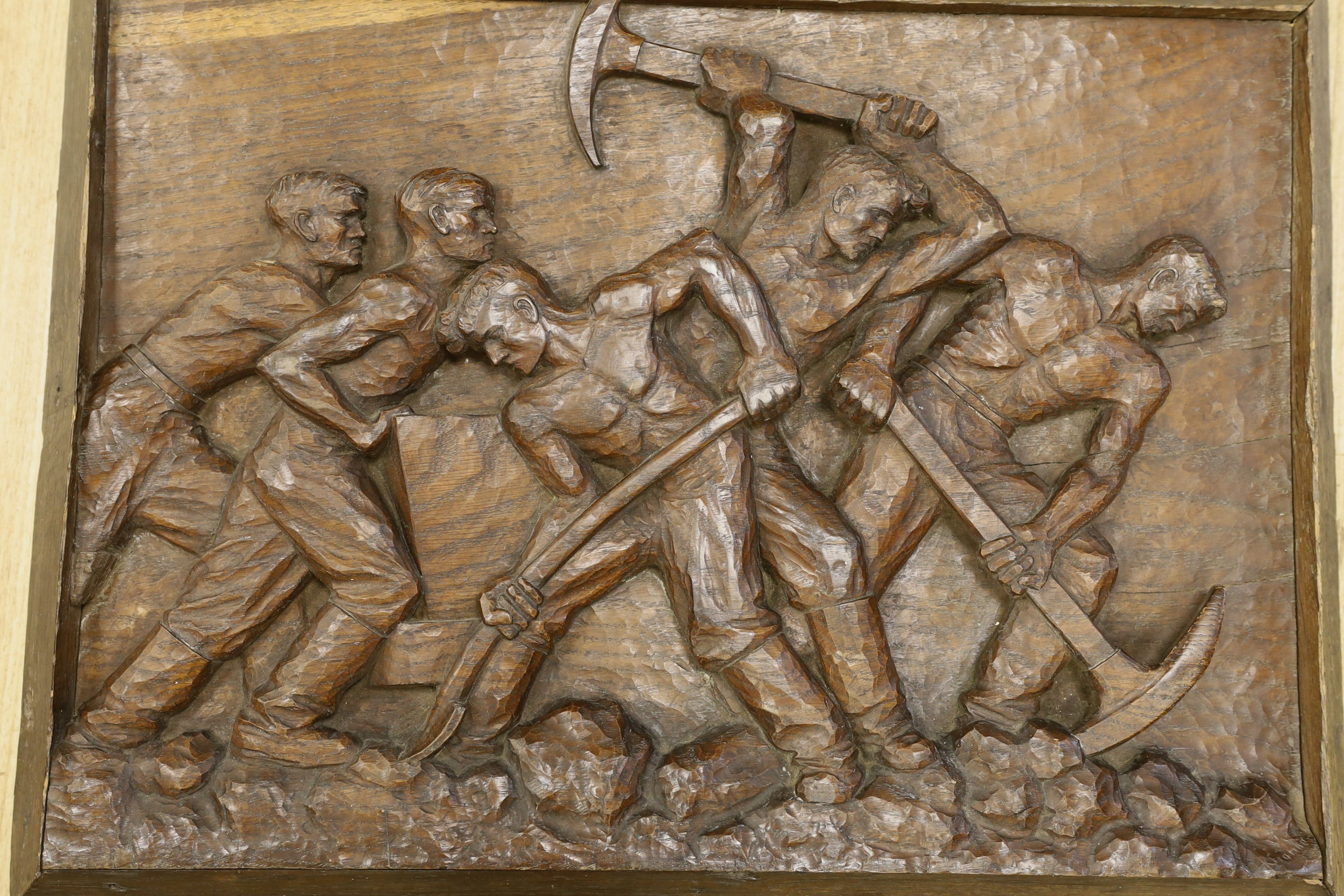 K Franke, a 1930’s carved oak panel of men digging possibly in a mine,66 cms wide x 49 cms high.